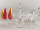 a lot of wine glasses and vases on the table