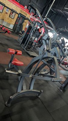 a gym with a row of exercise equipment in it