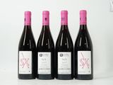 three bottles of wine are lined up on a white surface