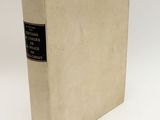 a white book with a black label on it sitting on a white surface