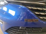 a close up of a blue car with a sticker on it