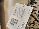 an image of a neck tie with a price tag on it