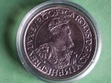 a close up of a coin on a green surface