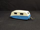 a blue and white toy boat on a black surface