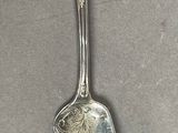 a silver spoon with a silver handle on a table