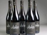 three bottles of wine sitting on top of a table next to each other