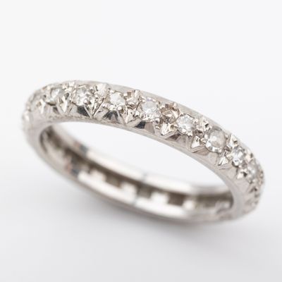a close up of a diamond ring on a white background