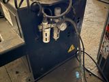 an image of a machine that is working on a piece of metal