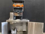 an image of a machine with oranges in it