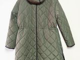 the jacket is green and black with a hood on it