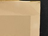 an image of a piece of cardboard on a black surface