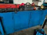 a blue cabinet with tools on it in a garage
