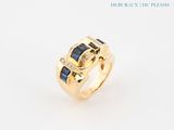 a close up of a gold ring with blue sapphires and diamonds