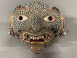 an image of a mask made of metal and glass