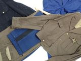 two jackets and a wallet sitting on a bed