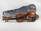 a violin that is sitting in a case on the ground