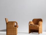 two wicker chairs and a coffee table in a white room