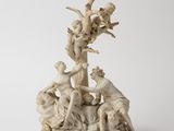 an image of a statue of a group of people on a rock