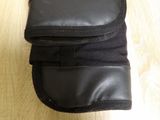 black leather case for a cell phone on a wooden table
