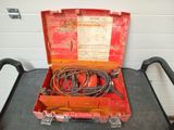 a red tool box with wires in it on a table