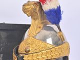 a helmet with a red, white, and blue feather on it