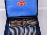a lot of silverware in a box on a table