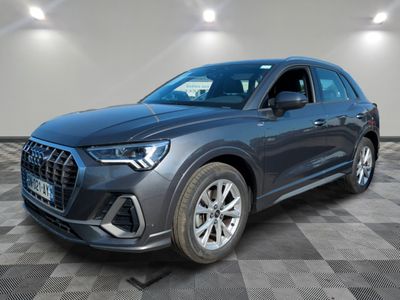 a grey 2020 audi qx parked in a large room