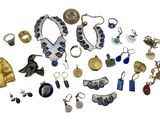 many different pieces of jewelry on a white surface
