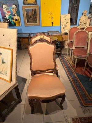 une pièce avec beaucoup de chaises et des tableaux accrochés aux murs
