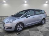 a picture of a silver minivan parked in a garage