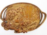 a gold belt buckle with a picture of a bull on it
