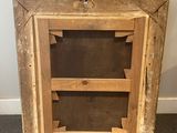 an old wooden picture frame with two shelves in it