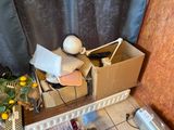 a pile of boxes and a lamp on the floor