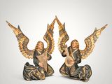 pair of angel figurines with musical instruments on a white background