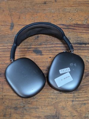 an image of a pair of headphones sitting on top of a wooden table