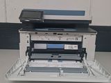 the printer is sitting on top of the tray on the table