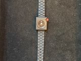 the watch is laying on the floor next to the wall
