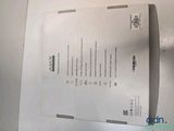 a white box with a paper on it sitting on top of a table