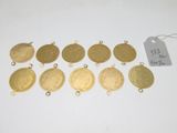 a bunch of gold coins and tags on a white surface