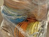 a pile of wires wrapped in plastic on a pallet