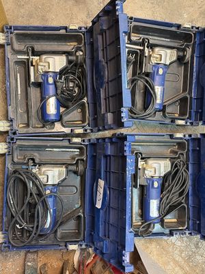 four blue boxes with tools in them sitting on the floor