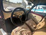 a car with a steering wheel and some pillows in it