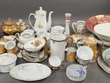 many different types of dishes and cups on the table
