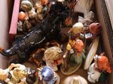 a box full of figurines sitting on the floor