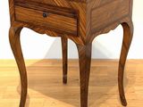 a small wooden table with a glass top on a hard wood floor