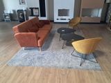 a living room with a couch, chair, coffee table and fireplace