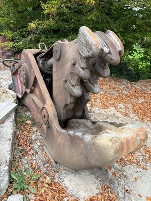 a statue of a man sitting on a bench in the park