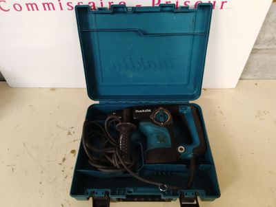 a blue box with a drill in it on the floor