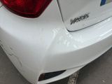 a close up of a car ' s rear end with a denting on it