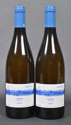two bottles of wine sitting next to each other on a table